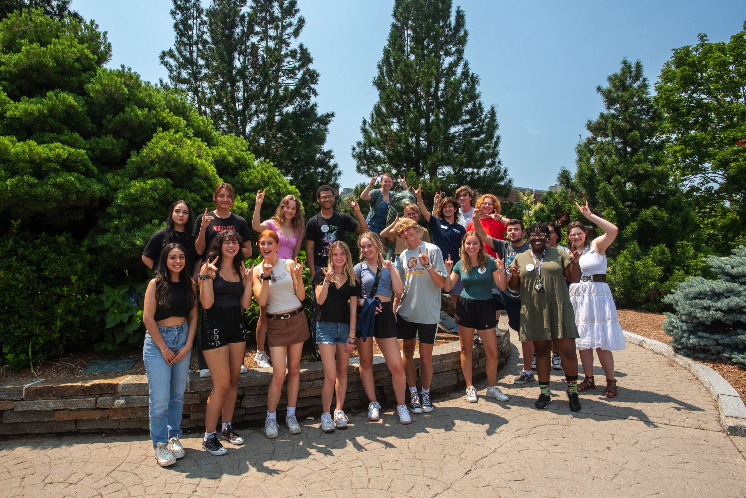 First-year Orientation students posing for a photo with the Jonathan statue on July 11, 2023. (Sean Flynn/UConn Photo)