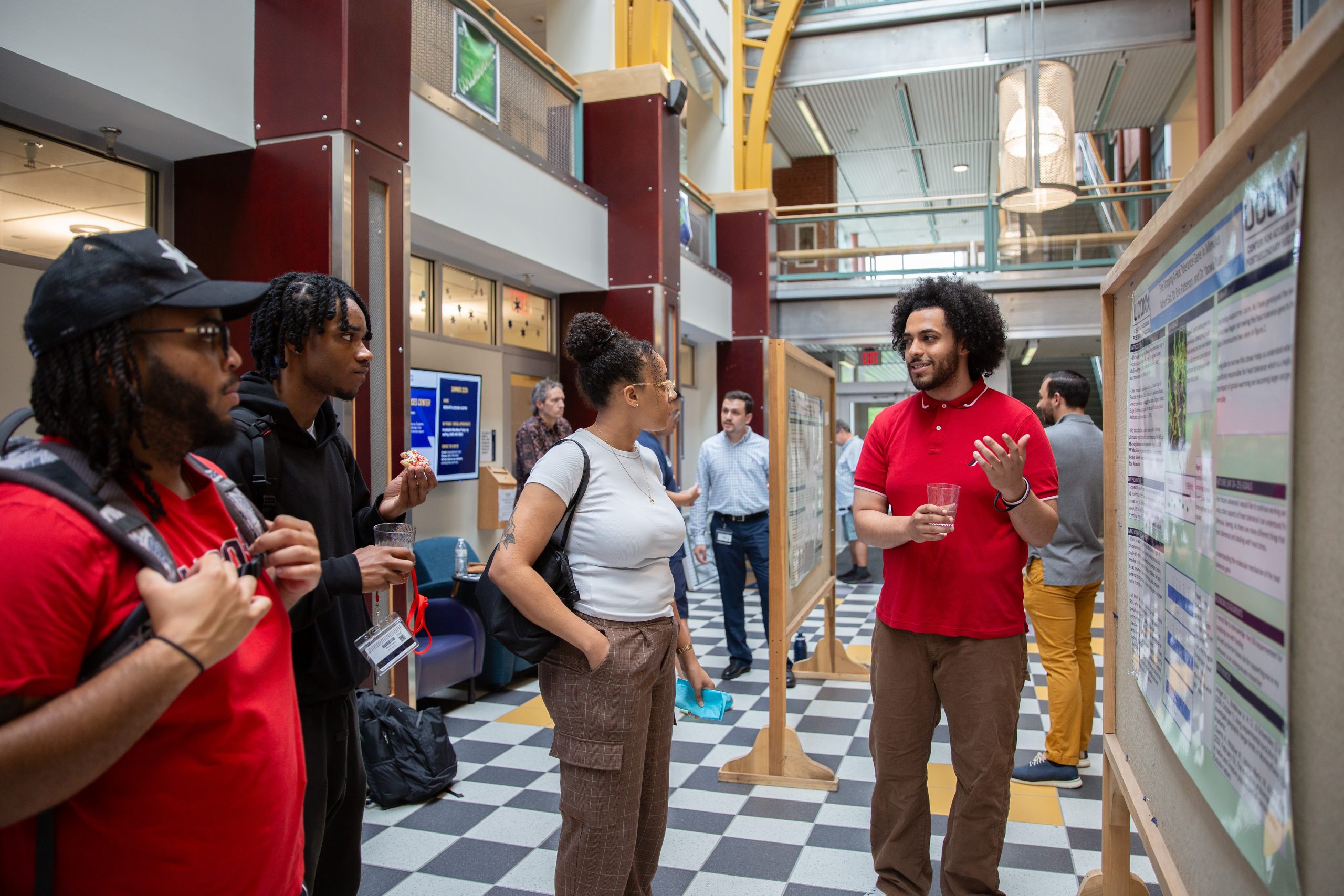 Adhem Gad, an ecology and evolutionary biology major and CAPS Research Scholar, presents at the Center for Access and Postsecondary Success (CAPS) Research Summer Poster Exhibit in the Rowe Center for Undergraduate Education Building on July 24, 2024. (Bri Diaz/UConn Photo).