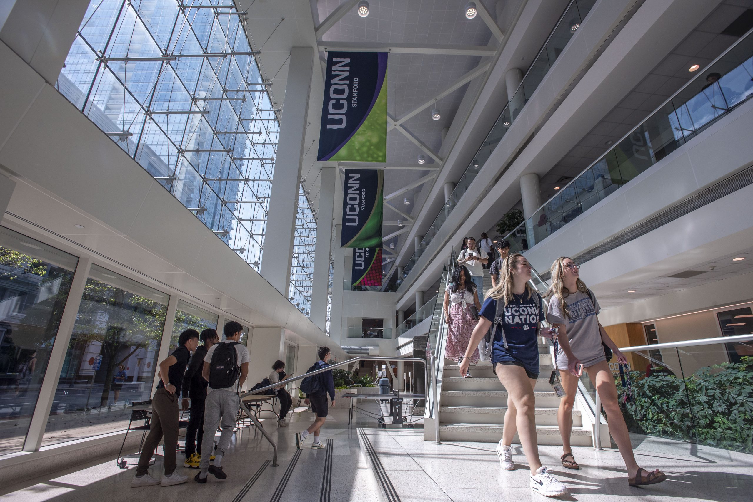stamford-240919c0073.jpg Students walking down the stairs in the courtyard (atrium) UConn Stamford on Sept. 19, 2024. (Sean Flynn/UConn Photo)