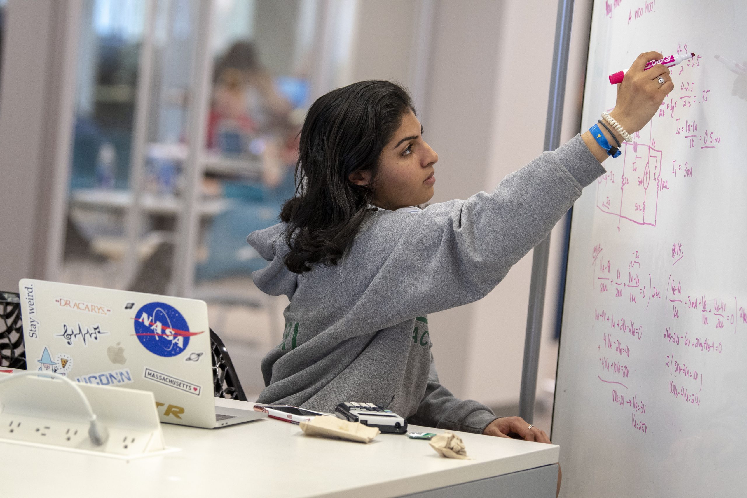 Student writing on a whiteboard in the Homer babbidge library on May 2, 2018. (Sean Flynn/UConn Photo)